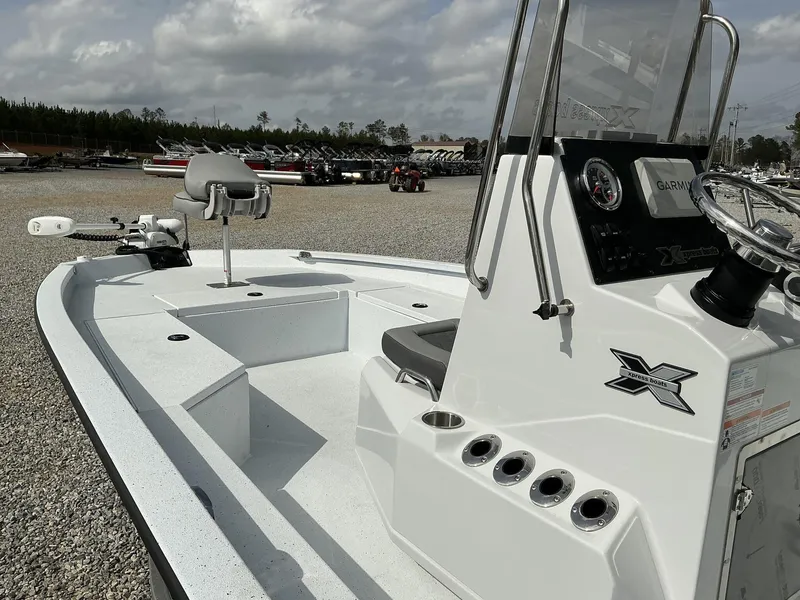 Slide: The Image of 2025 Xpress Hyper-Lift Series H22B boat with console and seating, displayed outdoors. - 5