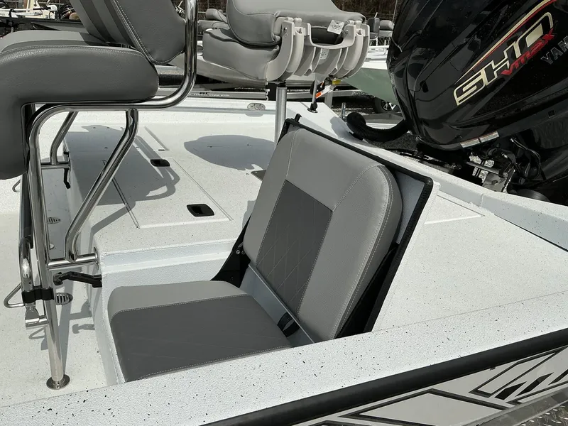 Slide: The Image of 2025 Xpress Hyper-Lift Series H22B boat interior with gray seating and Yamaha engine. - 7