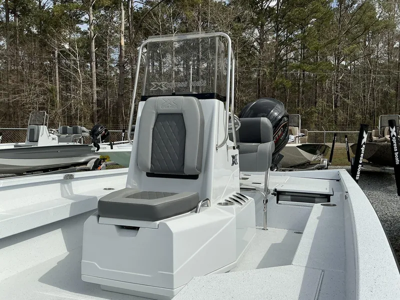 Slide: The Image of 2025 Xpress Hyper-Lift Series H22B boat with seating and console, outdoors. - 9