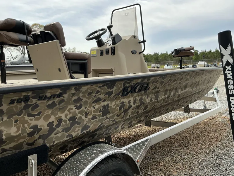 Slide: The Image of 2025 Excel Bay Pro 203 Elite boat with camouflage design on a trailer. - 6
