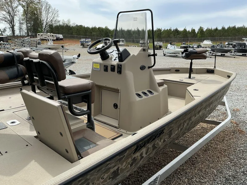 Slide: The Image of 2025 Excel Bay Pro 203 Elite boat with console and seating, displayed outdoors. - 7