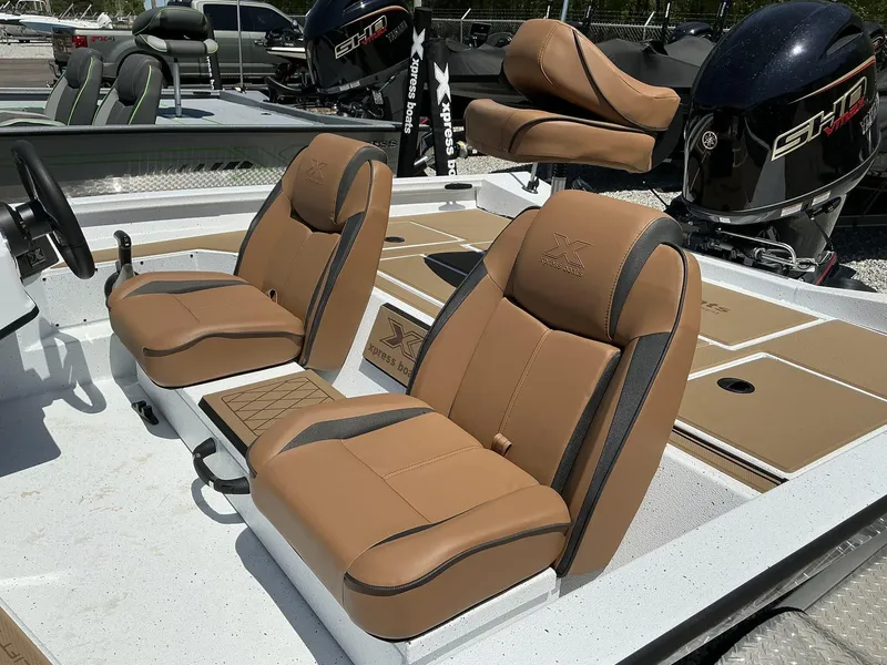 Slide: The Image of 2025 Xpress Hyper-Lift Series H18 bass boat with tan seating and powerful engine. - 4
