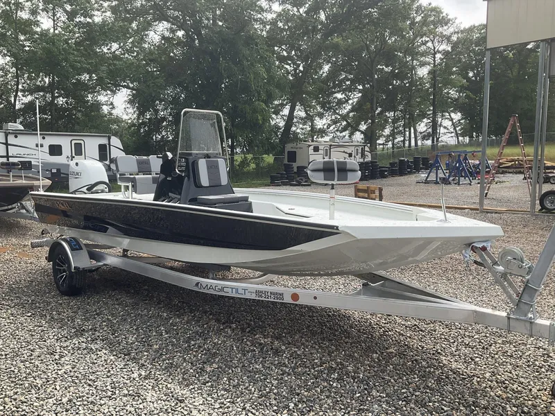 Slide: The Image of 2025 Excel Bay Pro 203 Elite boat on trailer, parked outdoors. - 2