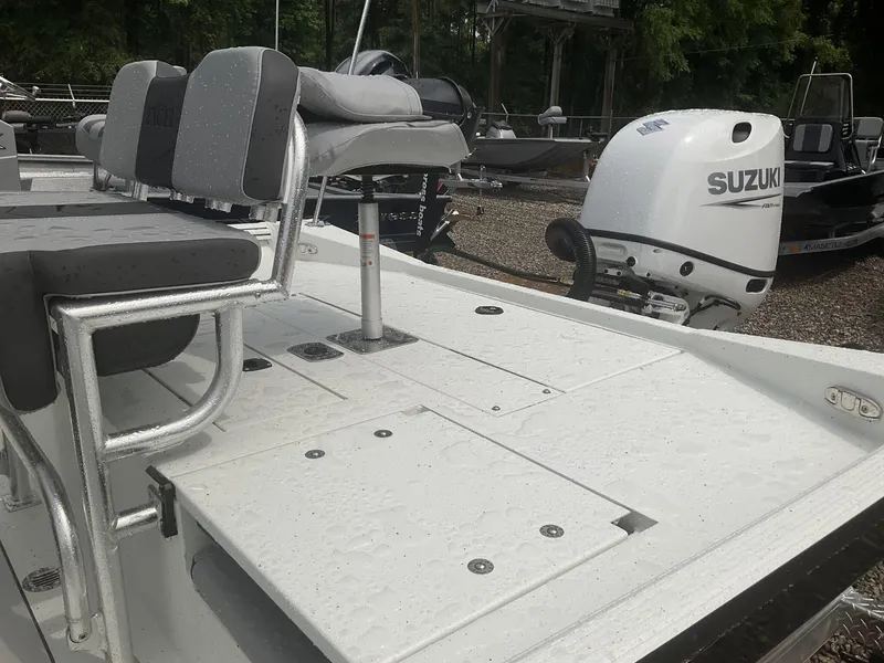 Slide: The Image of 2025 Excel Bay Pro 203 Elite boat with Suzuki outboard motor, featuring cushioned seating. - 9