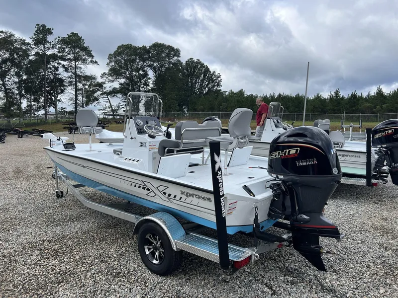 Slide: The Image of 2025 Xpress Hyper-Lift Series H20B boat with new console, parked on gravel lot. - 3