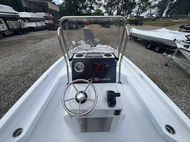 Slide: The Image of 2025 Xpress Hyper-Lift Series H20B boat console with steering wheel and controls. - 6