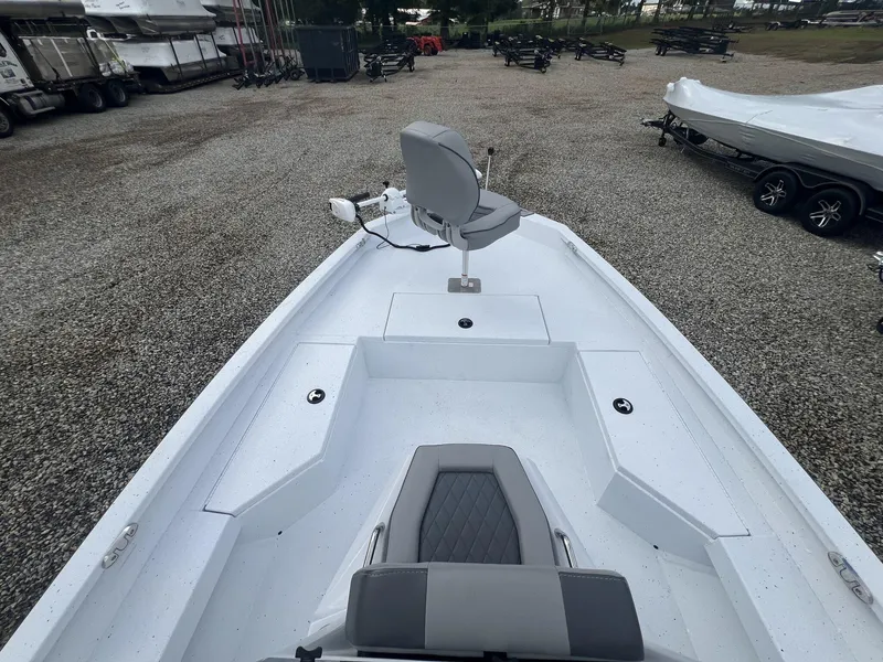 Slide: The Image of 2025 Xpress Hyper-Lift Series H20B boat with new console, parked on gravel. - 7