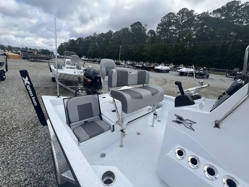 Slide: The Image of 2025 Xpress Hyper-Lift Series H20B boat with new console, parked outdoors. - 8