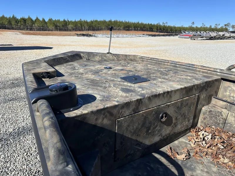 Slide: The Image of 2025 Excel Viper F4 1754 ECLIPSE boat with camo design, parked outdoors. - 4