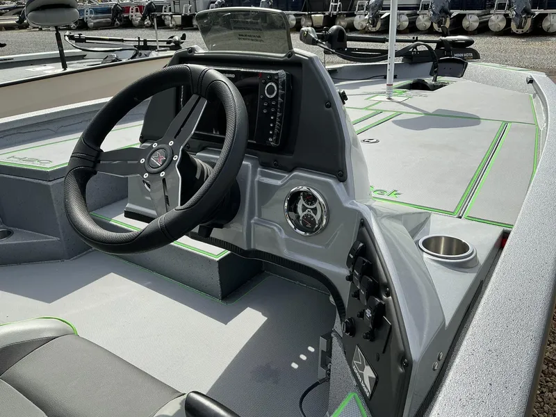 Slide: The Image of 2025 Xpress Hyper-Lift Bass Series boat interior with steering wheel and control panel. - 6
