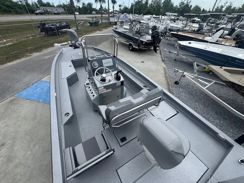 Slide: The Image of 2025 Xpress Hyper-Lift Series H22B boat, gray interior, parked in a dealership lot. - 10