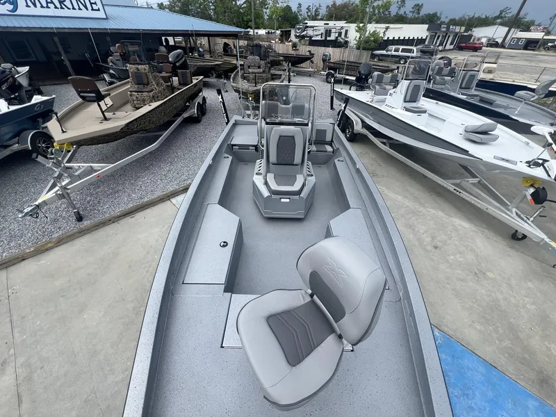Slide: The Image of 2025 Xpress Hyper-Lift Series H22B boat displayed at a marine dealership. - 11