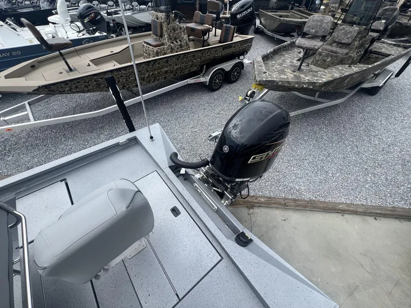 Slide: The Image of 2025 Xpress Hyper-Lift Series H22B boat with Yamaha outboard motor, parked on gravel. - 9