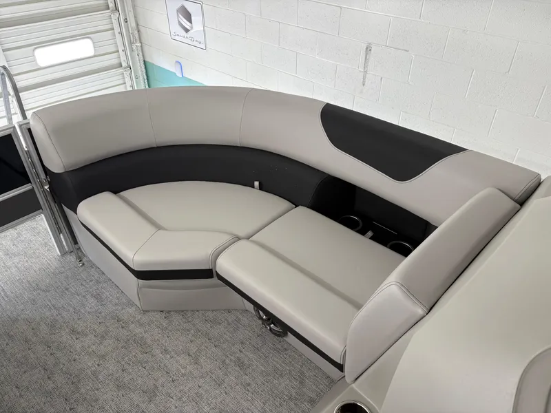 Slide: The Image of 2025 South Bay 222FCR boat interior with gray seating and cup holders. - 11