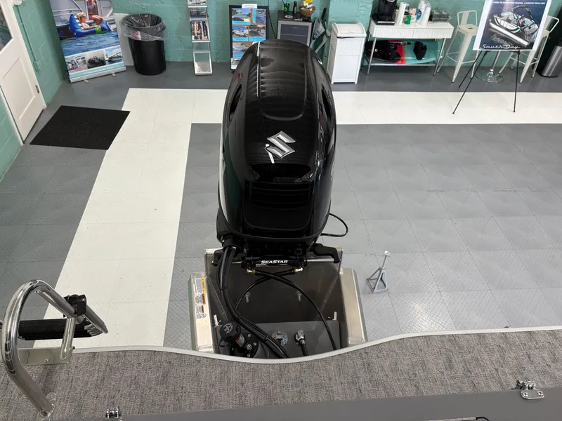 Slide: The Image of 2025 South Bay 222FCR boat with Suzuki outboard motor in showroom. - 6