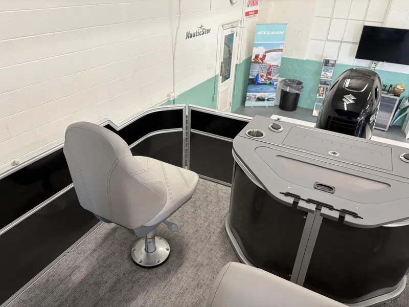 Slide: The Image of 2025 South Bay 222FCR boat interior with seating and control panel in showroom. - 7