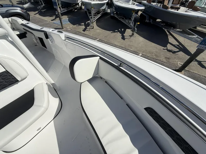 Slide: The Image of 2025 Tidewater 220 LXF boat interior with white seating and black accents. - 11