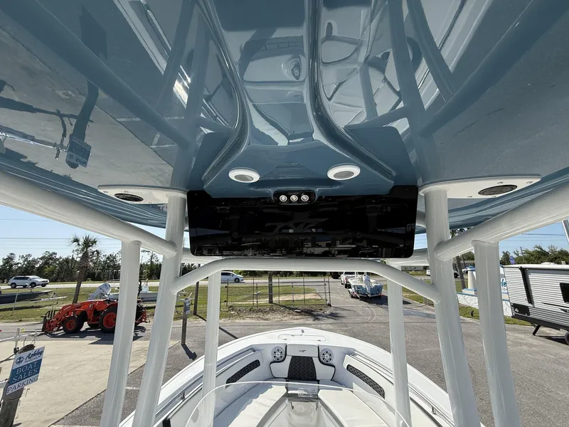 Slide: The Image of 2025 Tidewater 220 LXF boat interior view with T-top and seating area. - 8