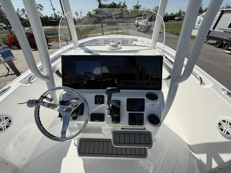 Slide: The Image of 2025 Tidewater 220 LXF boat dashboard with steering wheel and electronic controls. - 9