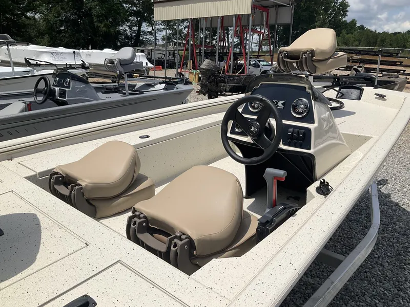 Slide: The Image of 2024 Xpress Xplorer Series XP170 boat with beige seats and steering console. - 4
