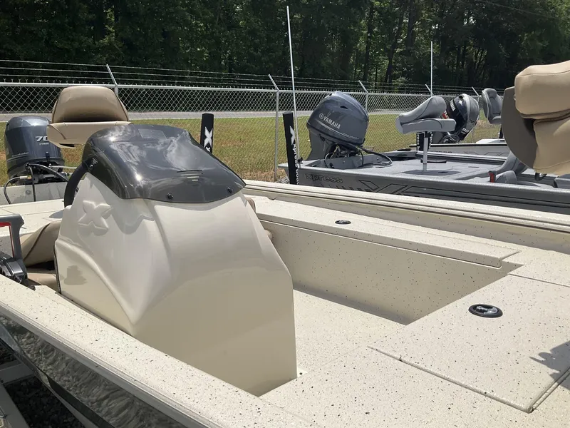 Slide: The Image of 2024 Xpress Xplorer Series XP170 boat with Yamaha outboard motor, parked outdoors. - 8