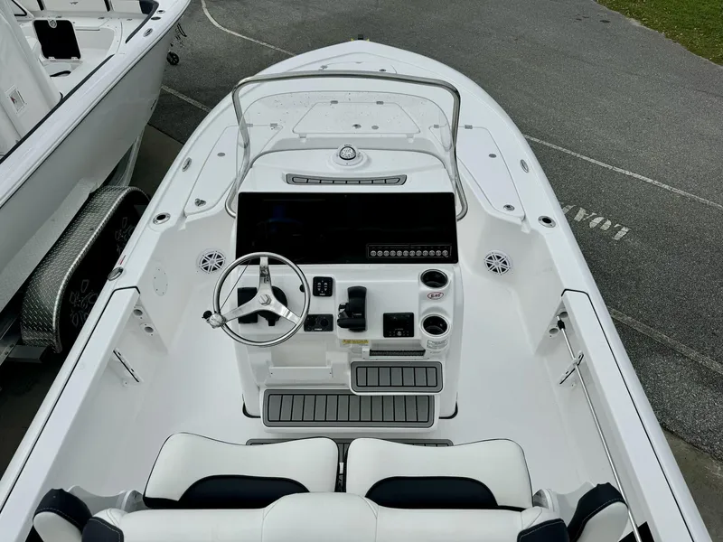 Slide: The Image of 2025 Tidewater 2110 Bay Max boat interior with steering console and seating. - 6