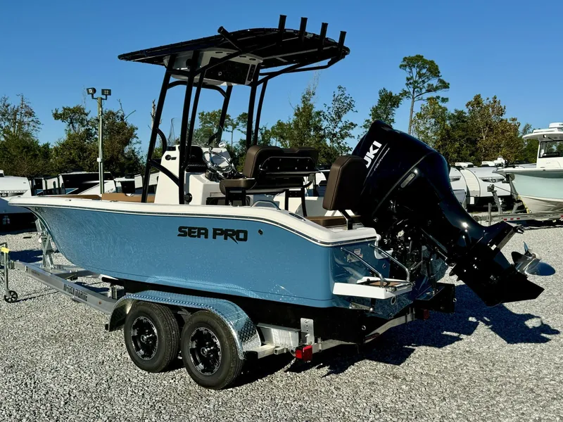 Slide: The Image of 2025 Sea Pro 202 boat on trailer with Suzuki outboard motor, parked outdoors. - 3