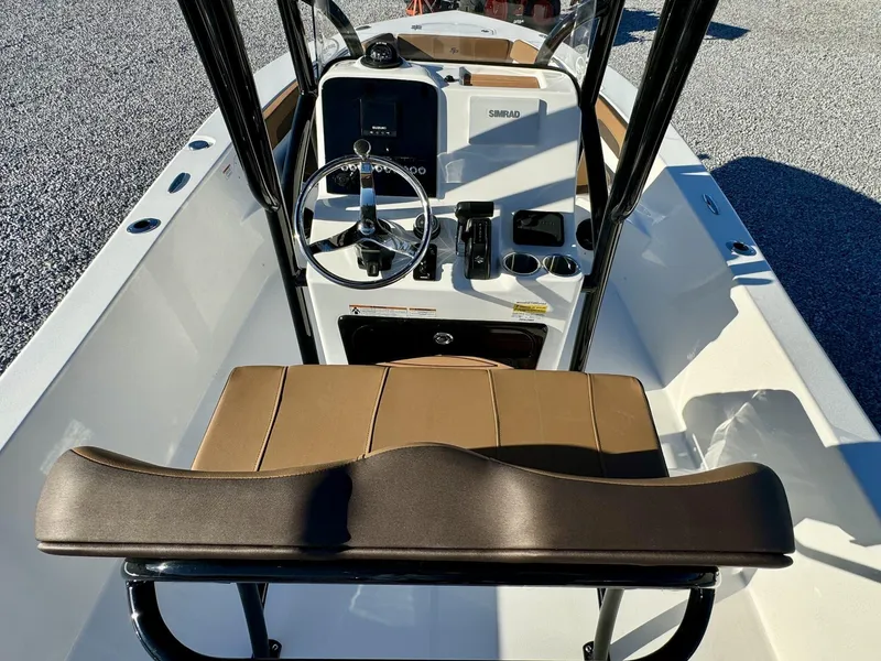 Slide: The Image of 2025 Sea Pro 202 boat interior with steering wheel and brown seating. - 4