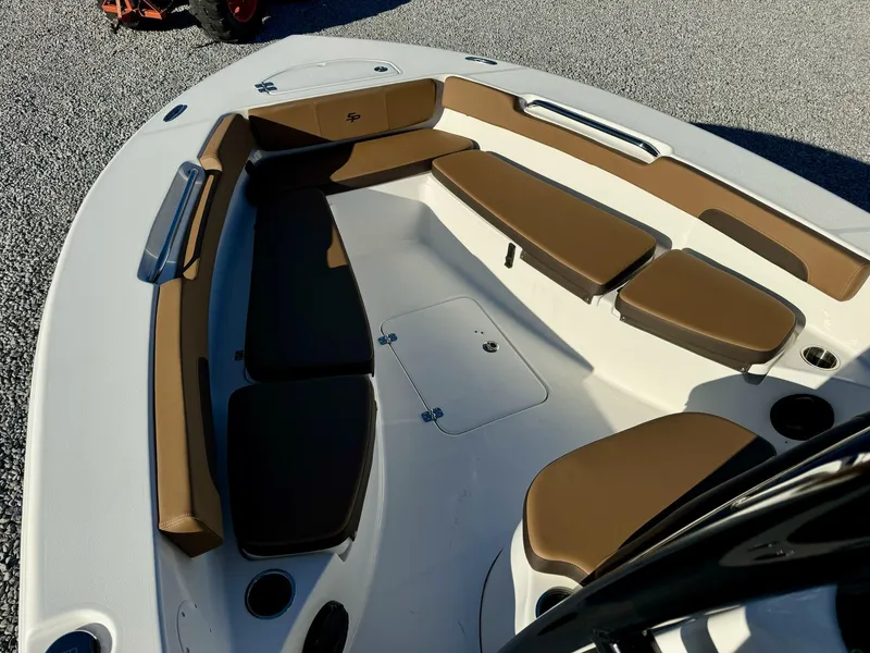 Slide: The Image of 2025 Sea Pro 202 boat interior with brown cushioned seating and storage compartments. - 7