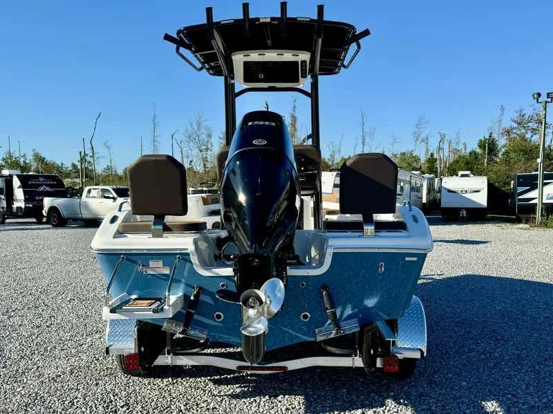 Slide: The Image of 2025 Sea Pro 202 boat with outboard motor, parked on gravel lot. - 8