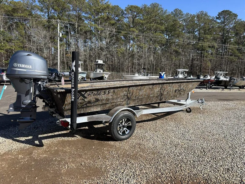 Slide: The Image of 2025 Xpress HD16DB boat with Yamaha motor on trailer, parked outdoors. - 8