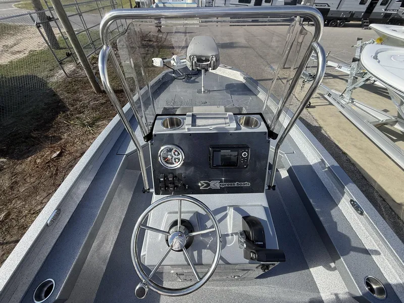 Slide: The Image of 2025 Xpress Hyper-Lift Series H20B boat console with steering wheel and navigation display. - 4
