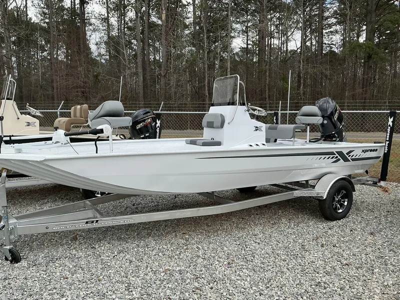 Slide: The Image of 2025 Xpress Xplorer Series XP20CC boat on trailer, parked outdoors. - 1