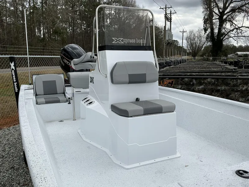 Slide: The Image of 2025 Xpress Xplorer Series XP20CC boat with center console and seating, outdoors. - 2