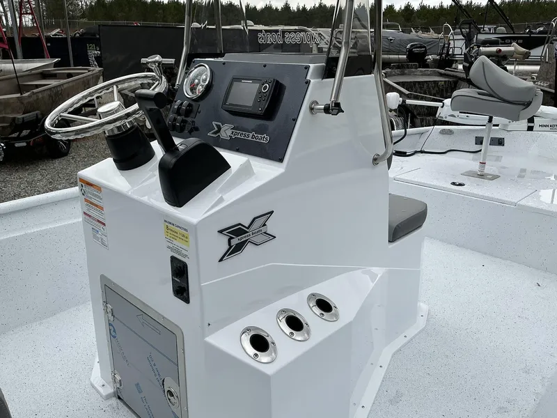 Slide: The Image of 2025 Xpress Xplorer Series XP20CC boat console with steering wheel and controls. - 9