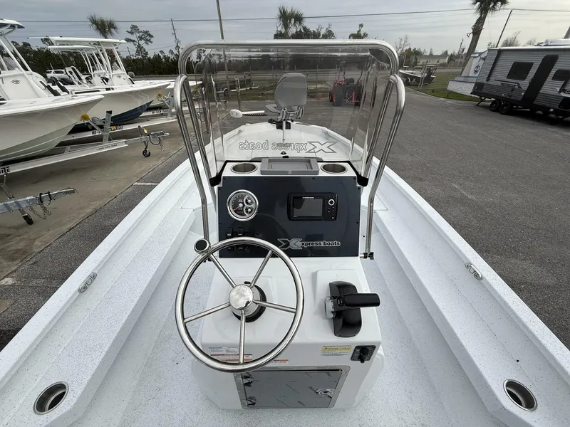 Slide: The Image of 2025 Xpress Hyper-Lift Series H22B boat interior with steering wheel and control panel. - 12