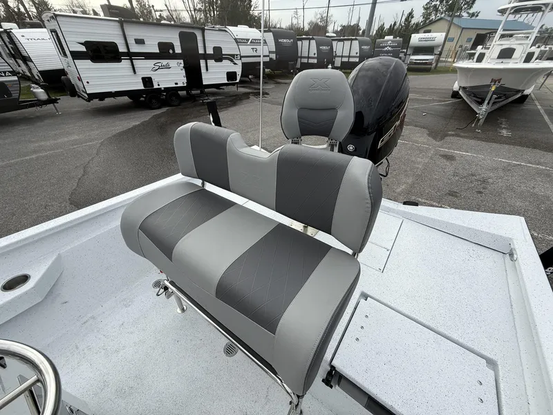 Slide: The Image of 2025 Xpress Hyper-Lift Series H22B boat with gray seating in a dealership lot. - 13