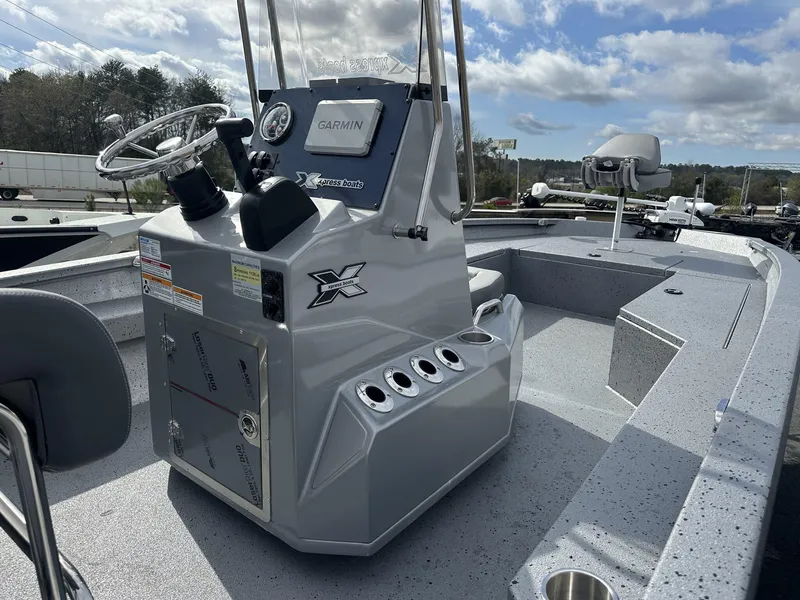 Slide: The Image of 2025 Xpress Hyper-Lift Series H22B boat interior with steering console and seating. - 8
