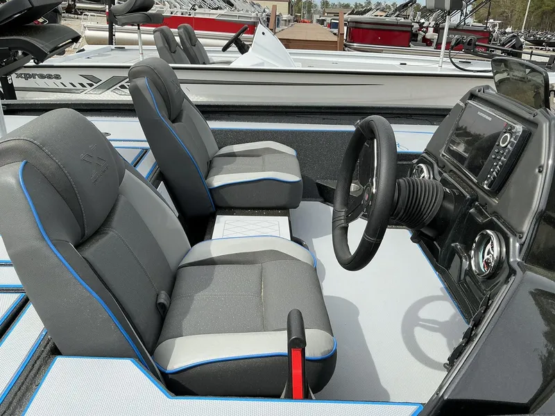 Slide: The Image of 2025 Xpress Hyper-Lift Crappie Series H20 boat interior with steering console and seating. - 4