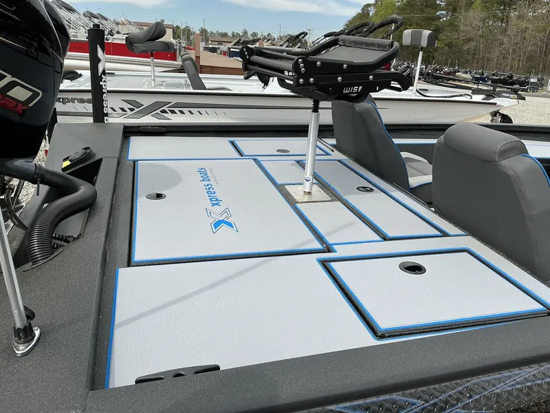 Slide: The Image of 2025 Xpress Hyper-Lift Crappie Series H20 boat interior with seating and storage compartments. - 6