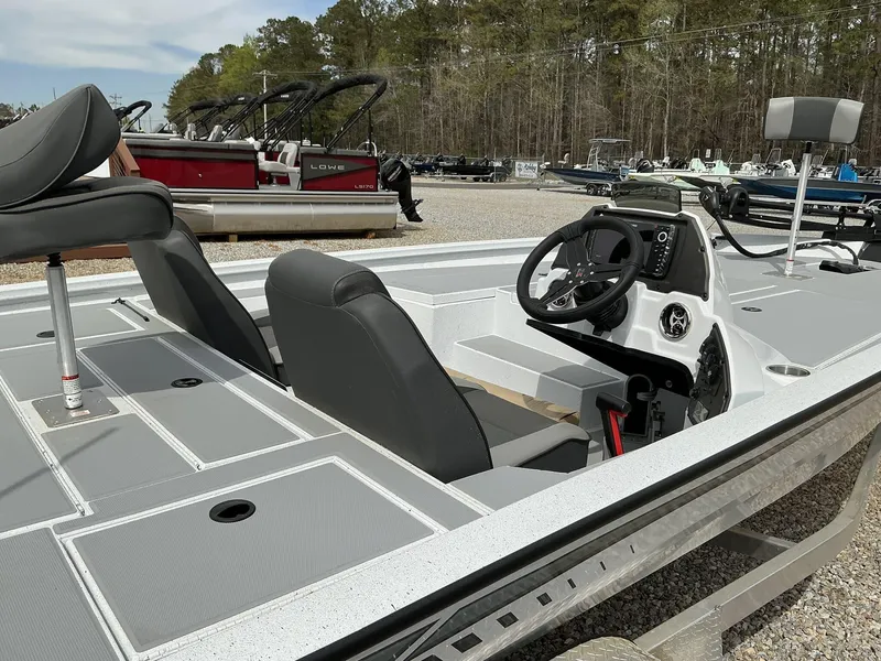 Slide: The Image of 2025 Xpress Hyper-Lift Bass Series boat interior with steering console and seating. - 5
