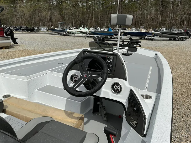 Slide: The Image of 2025 Xpress Hyper-Lift Bass Series boat interior with steering wheel and control panel. - 6