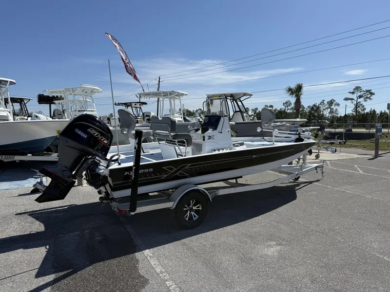 Slide: The Image of 2025 Xpress Hyper-Lift Series H20B boat with new console, parked on trailer. - 2