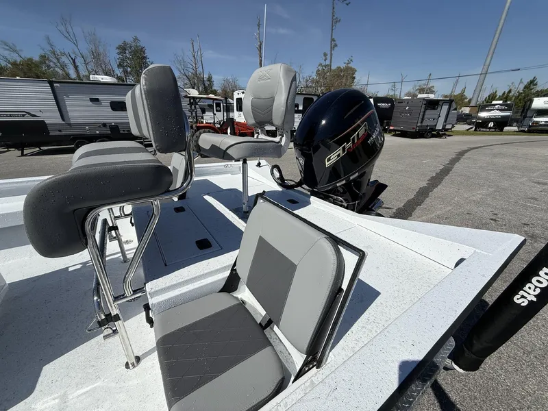 Slide: The Image of 2025 Xpress Hyper-Lift Series H20B boat with new console and seating, parked outdoors. - 4