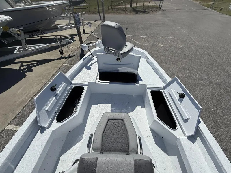Slide: The Image of 2025 Xpress Hyper-Lift Series H20B boat with open storage compartments and seating. - 9
