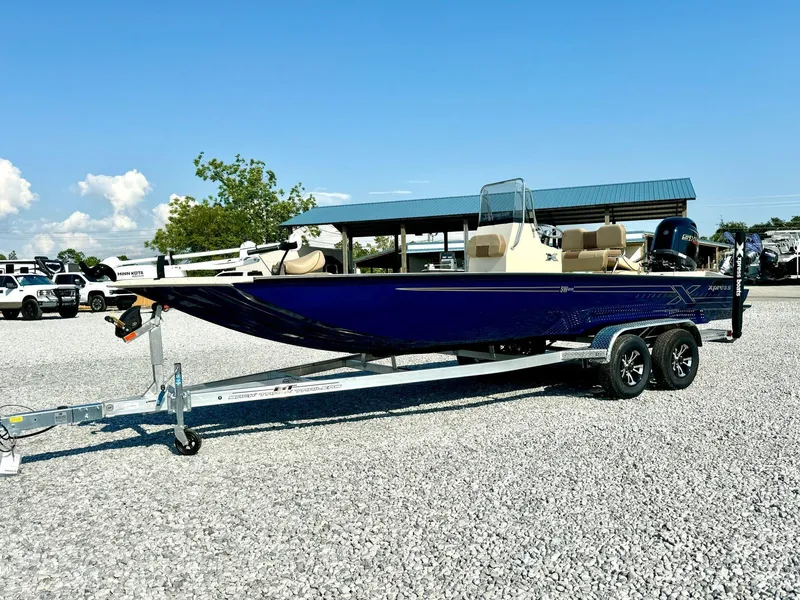 Slide: The Image of 2025 Xpress Shallow Water Series SW22B boat on trailer, parked outdoors. - 3