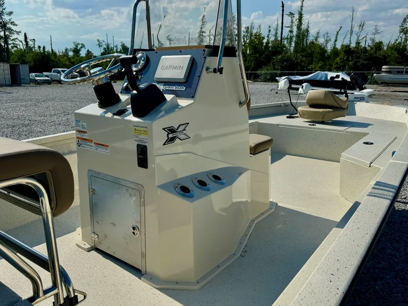 Slide: The Image of 2025 Xpress Shallow Water Series SW22B boat with Garmin system, parked outdoors. - 5