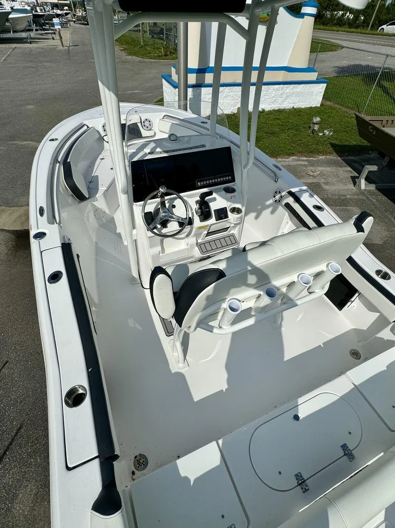 Slide: The Image of 2025 Tidewater 210 LXF boat interior with steering console and seating. - 5