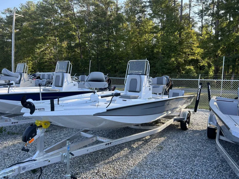 Slide: The Image of 2025 Xpress Hyper-Lift Series H20B boat with new console on a trailer, surrounded by trees. - 1