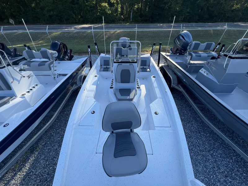 Slide: The Image of 2025 Xpress Hyper-Lift Series H20B boat with new console, parked outdoors. - 2